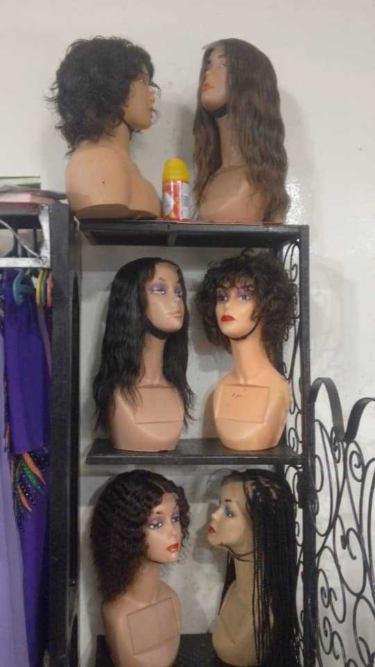 Wigs styled on stands, from short crops to long waves