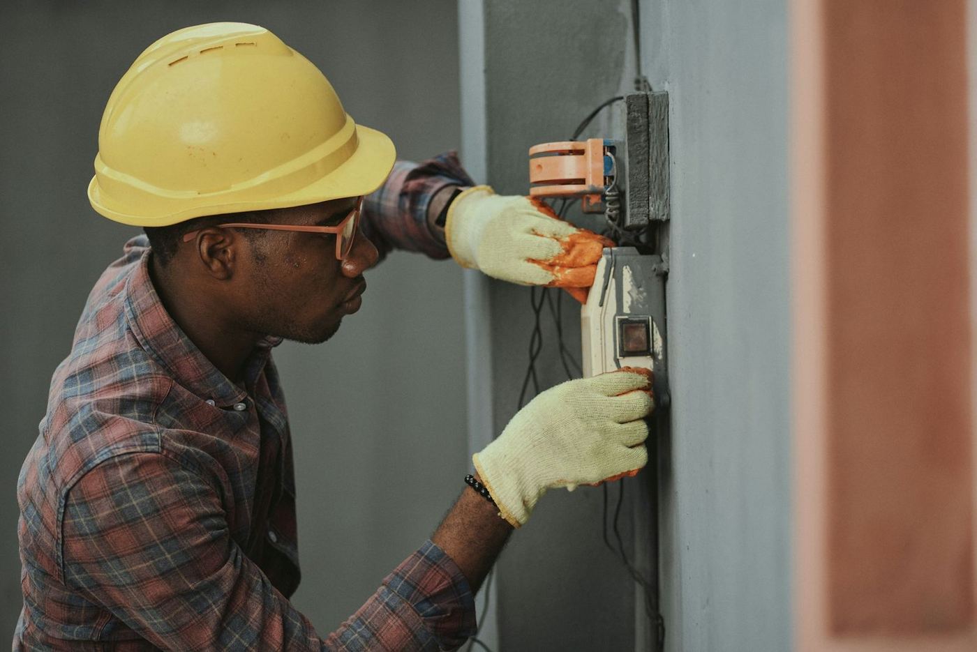 Electrician installing wiring on site