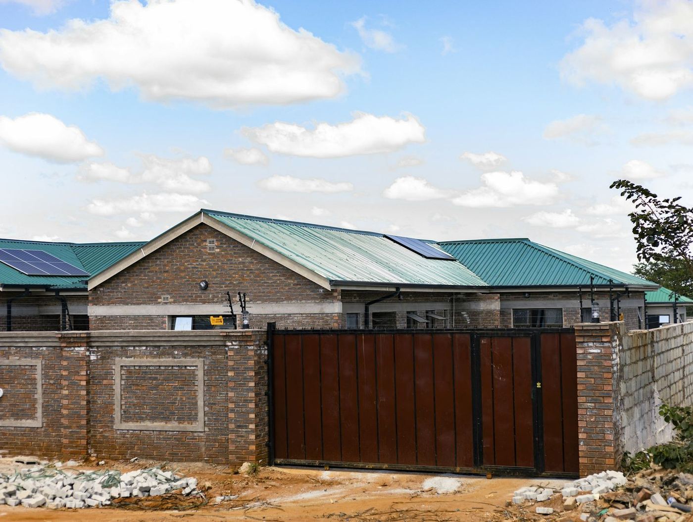 Rooftop solar on a home behind its gate